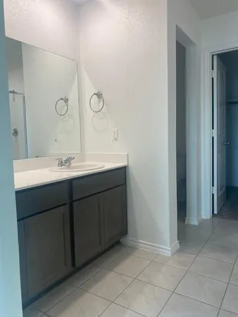 a bathroom with a double vanity sink and a mirror