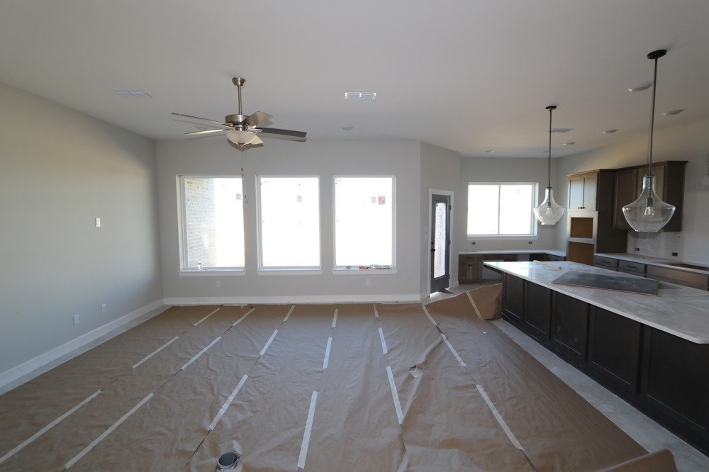 6623 Dolomite Court Manvel, TX 77578 - Photo 4 of 13 a large kitchen with granite countertop a stove a sink and a window