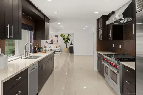 a kitchen with stainless steel appliances granite countertop a sink and a stove