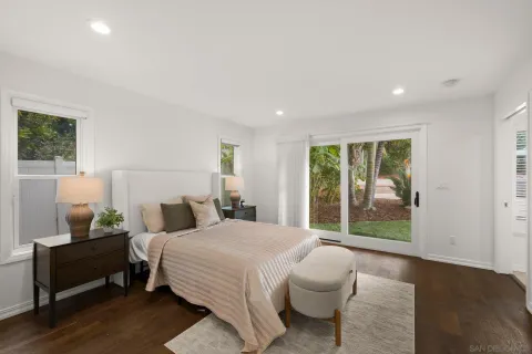 a bedroom with a bed and glass window