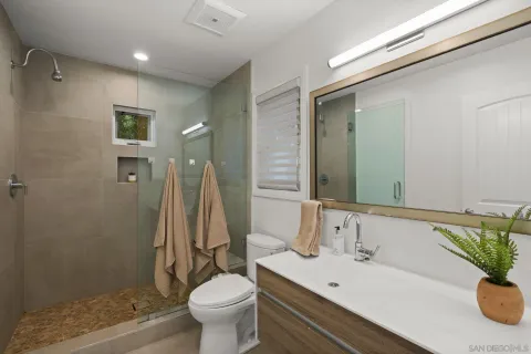 a bathroom with a sink toilet and shower