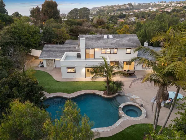 an aerial view of a house with garden space and ocean view