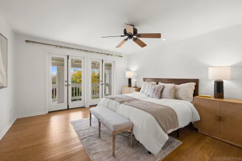 a spacious bedroom with a large bed and a large window