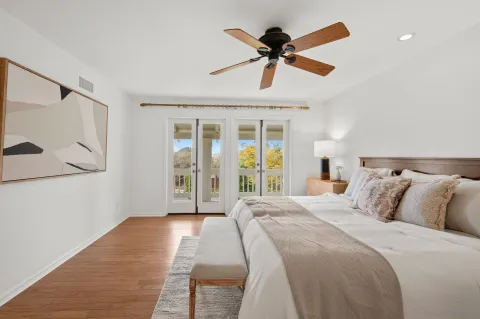 a bedroom with a bed and a painting on the wall