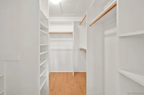 a view of a room with wooden floor