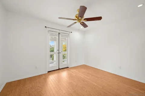 a view of a big room with wooden floor and a ceiling fan
