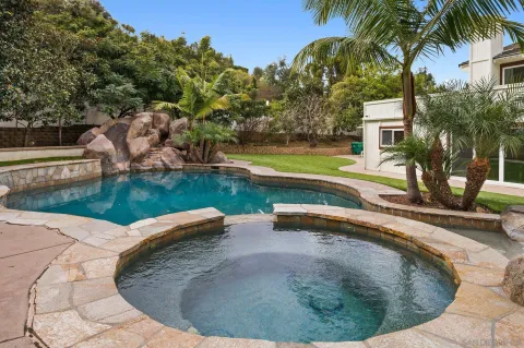 a view of a house with swimming pool and sitting area