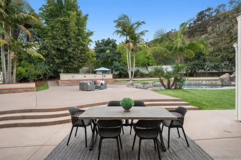 a view of a house with swimming pool and sitting area