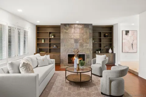 a living room with furniture and a fireplace