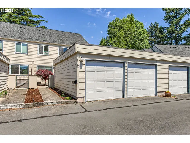 a view of a house with a yard and garage