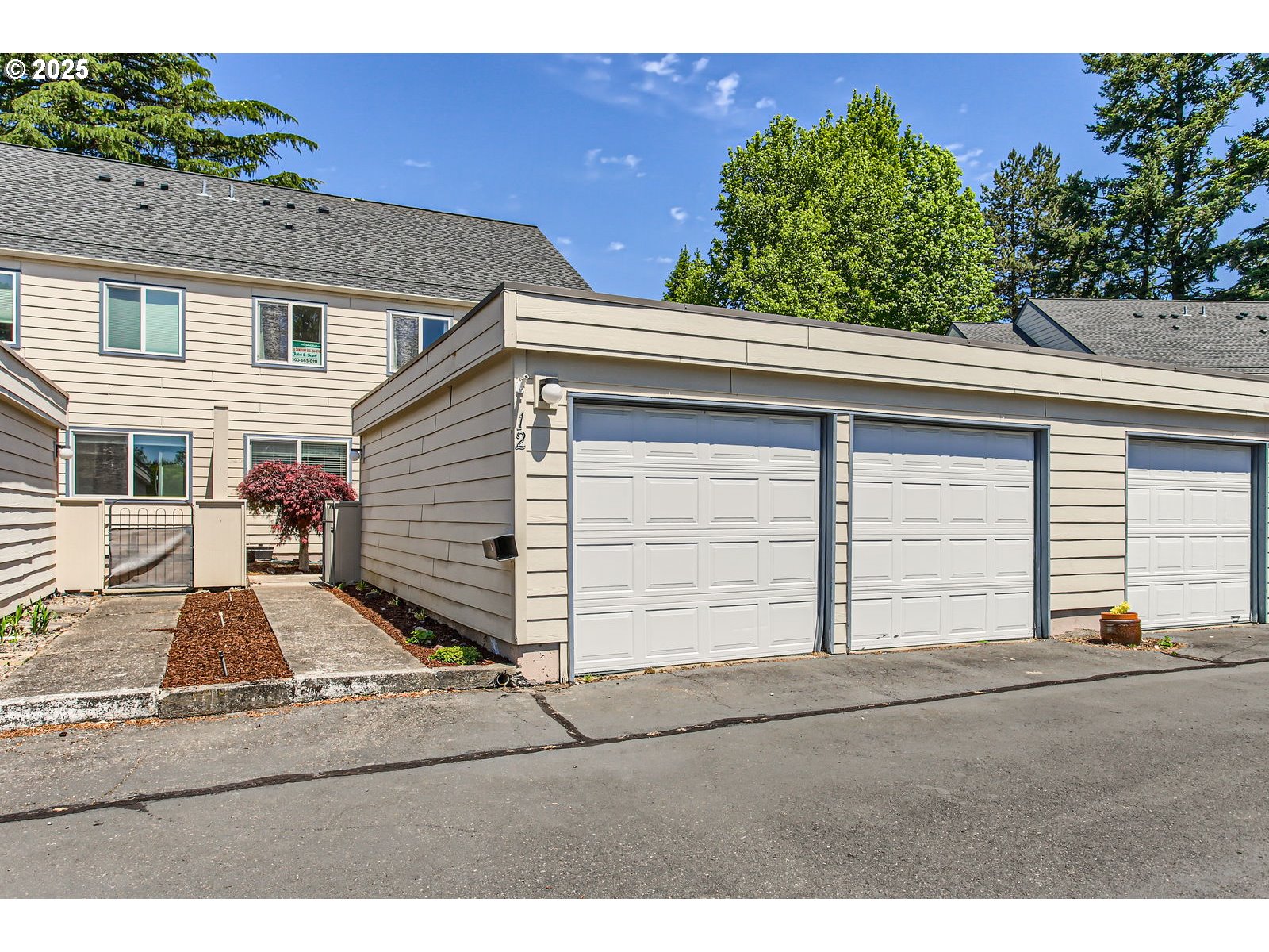 220 Northeast Village Squire Avenue, Unit 12 Gresham, OR 97030 - Photo 1 of 29 a view of a house with a yard and garage