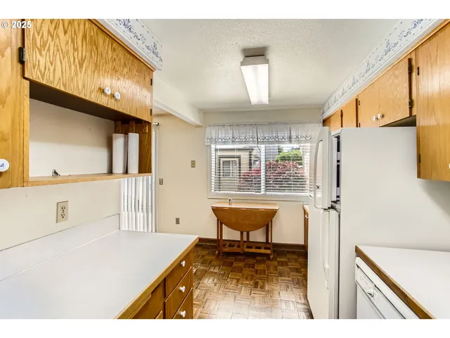 a kitchen with a sink and a refrigerator
