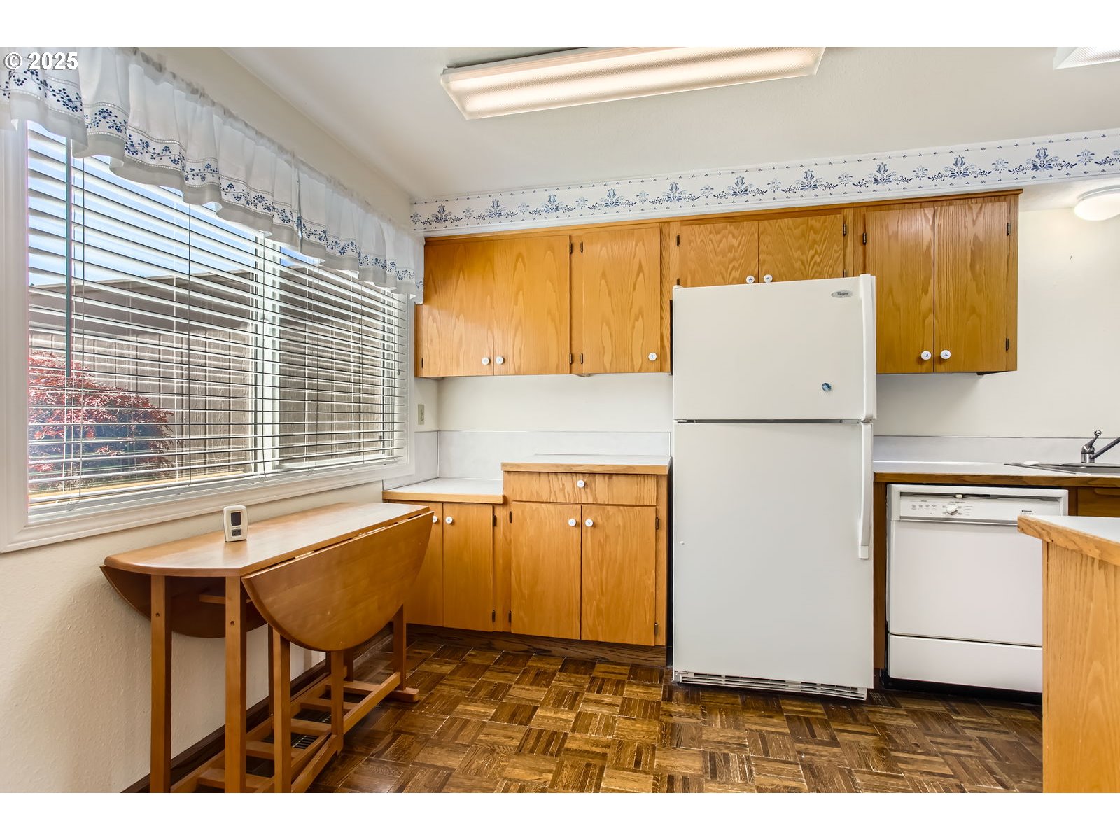220 Northeast Village Squire Avenue, Unit 12 Gresham, OR 97030 - Photo 14 of 29 a kitchen with a sink and a refrigerator