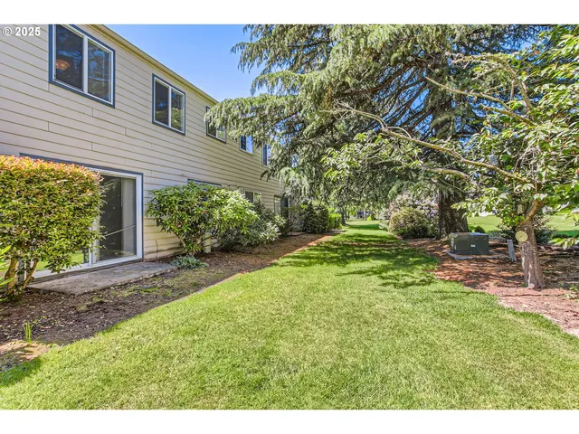 a front view of a house with yard and green space