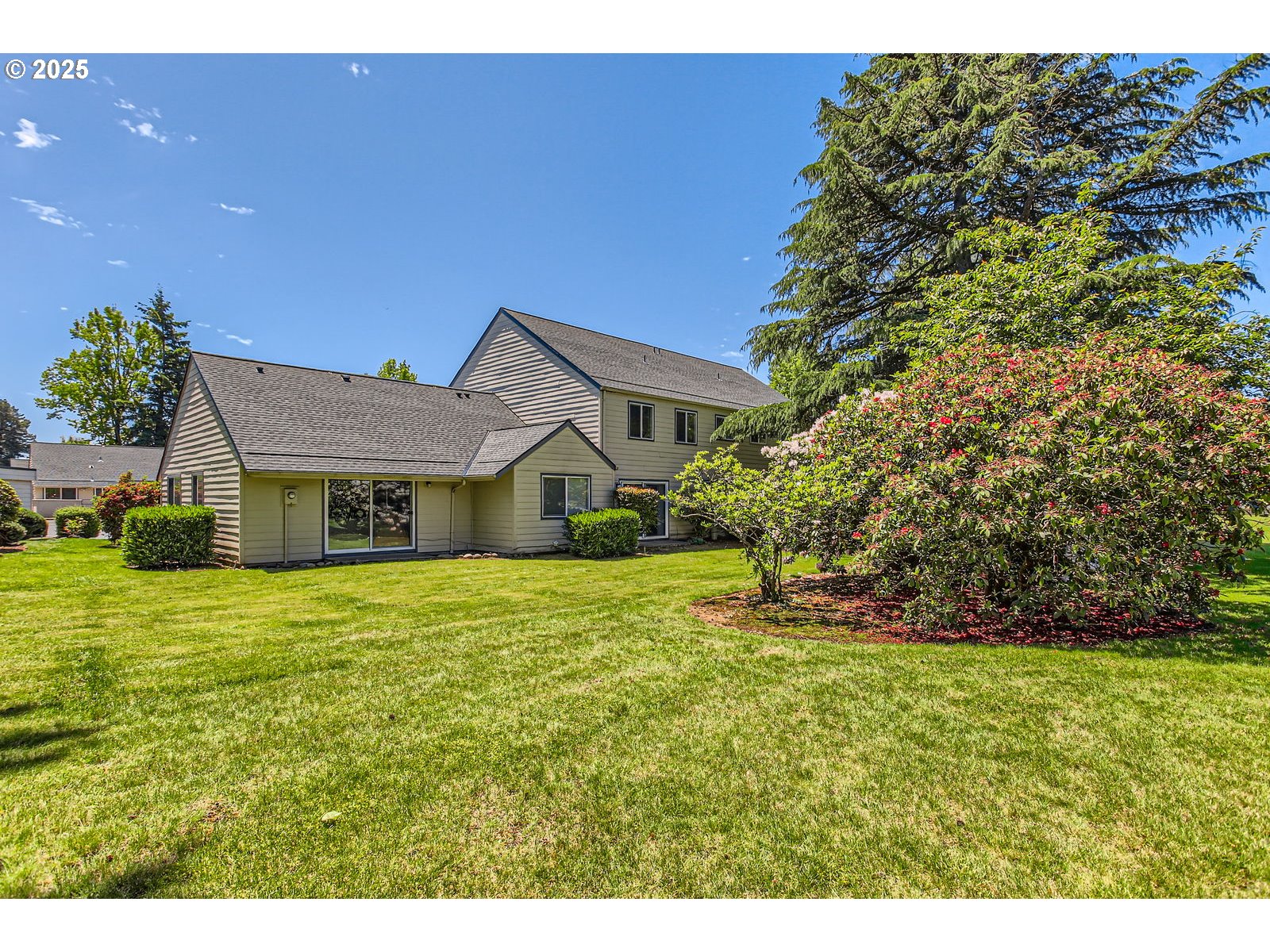 220 Northeast Village Squire Avenue, Unit 12 Gresham, OR 97030 - Photo 28 of 29 a front view of a house with yard and green space