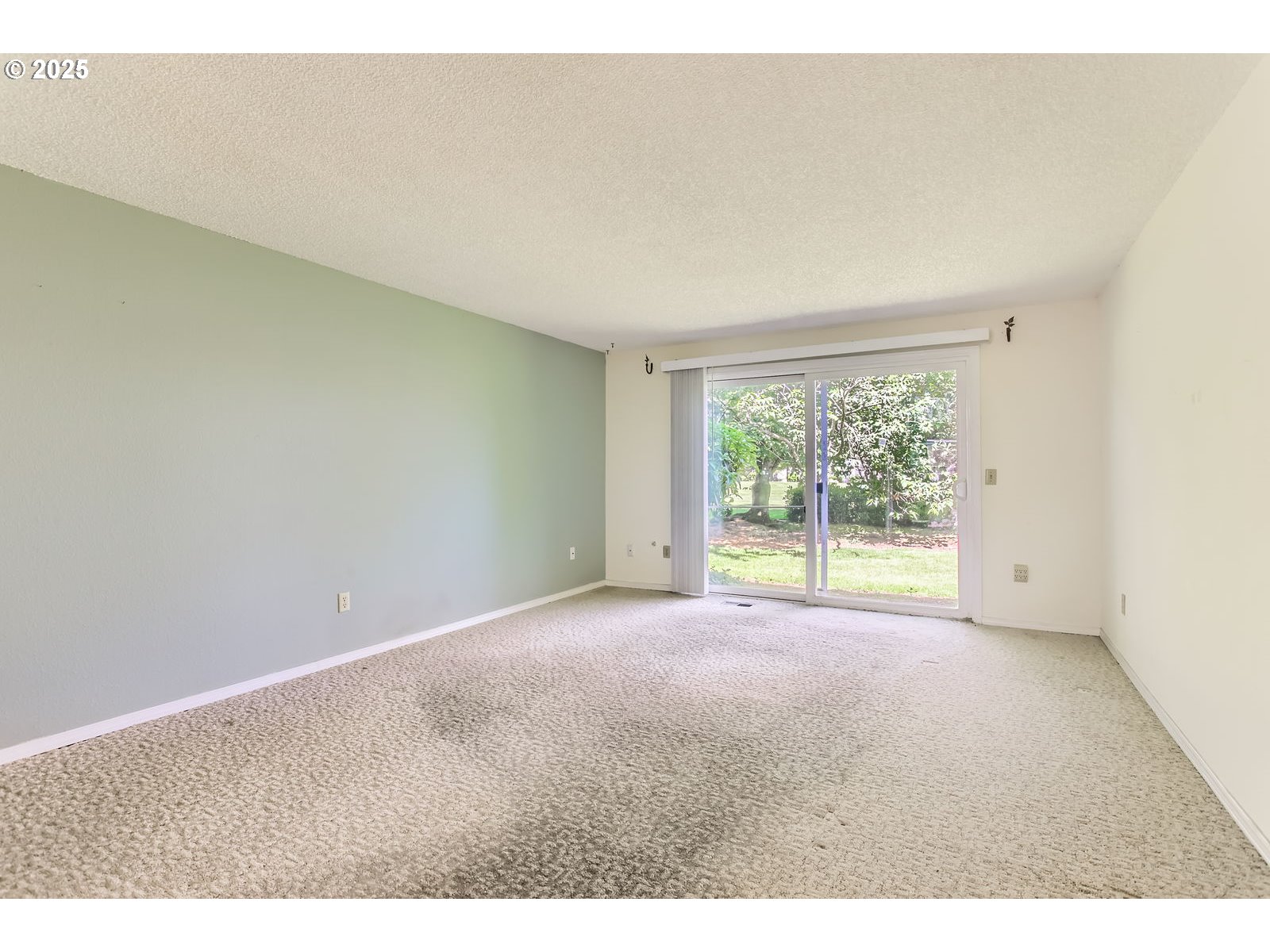 220 Northeast Village Squire Avenue, Unit 12 Gresham, OR 97030 - Photo 6 of 29 a view of an empty room with a window