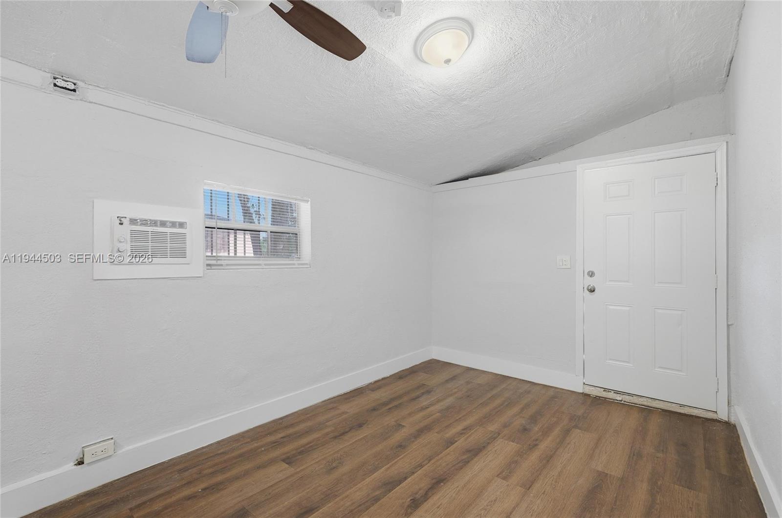 5401 Southwest 20th Street, Unit B West Park, FL 33023 - Photo 5 of 10 an empty room with wooden floor and windows