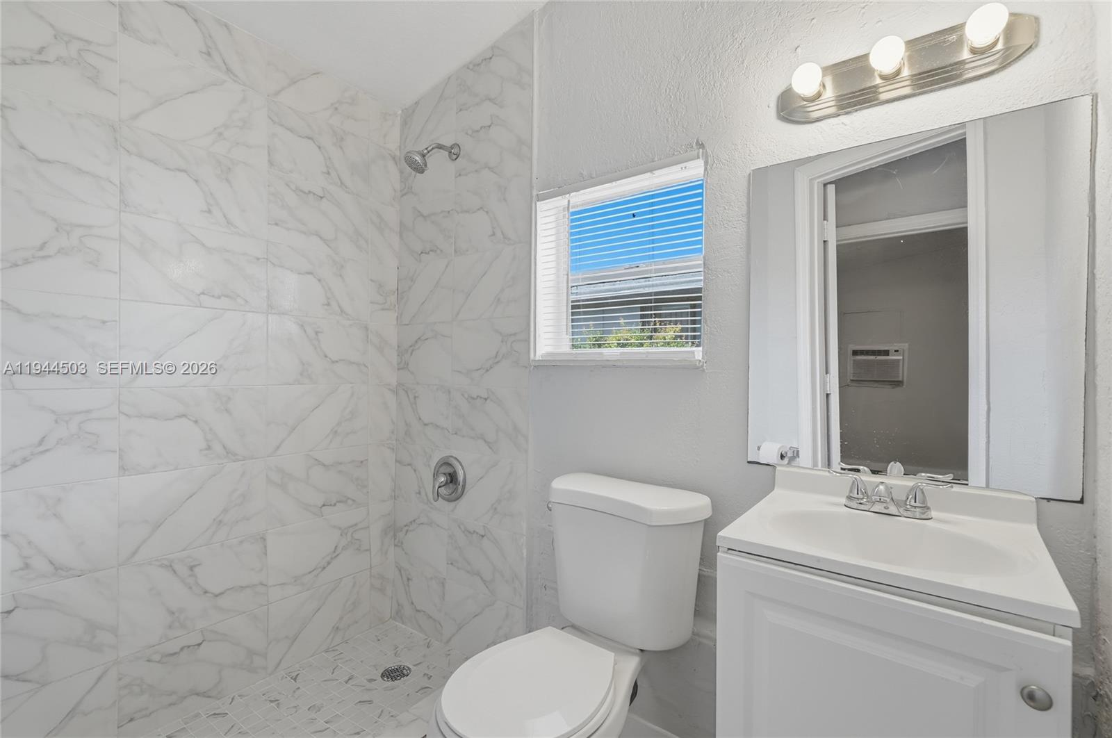 5401 Southwest 20th Street, Unit B West Park, FL 33023 - Photo 6 of 10 a bathroom with a toilet sink shower and mirror