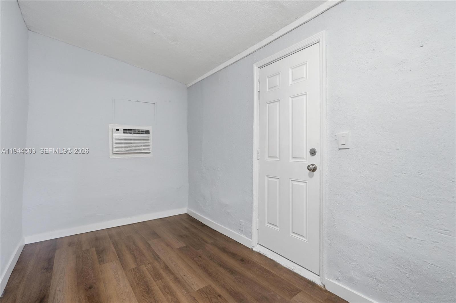 5401 Southwest 20th Street, Unit B West Park, FL 33023 - Photo 7 of 10 a view of a small space with wooden floor and a window
