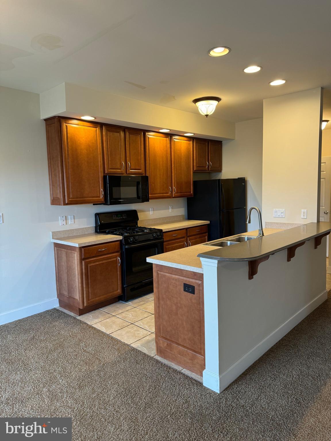 121 Scully Place Lewisberry, PA 17339 - Photo 9 of 11 a kitchen with kitchen island stainless steel appliances a sink stove and refrigerator