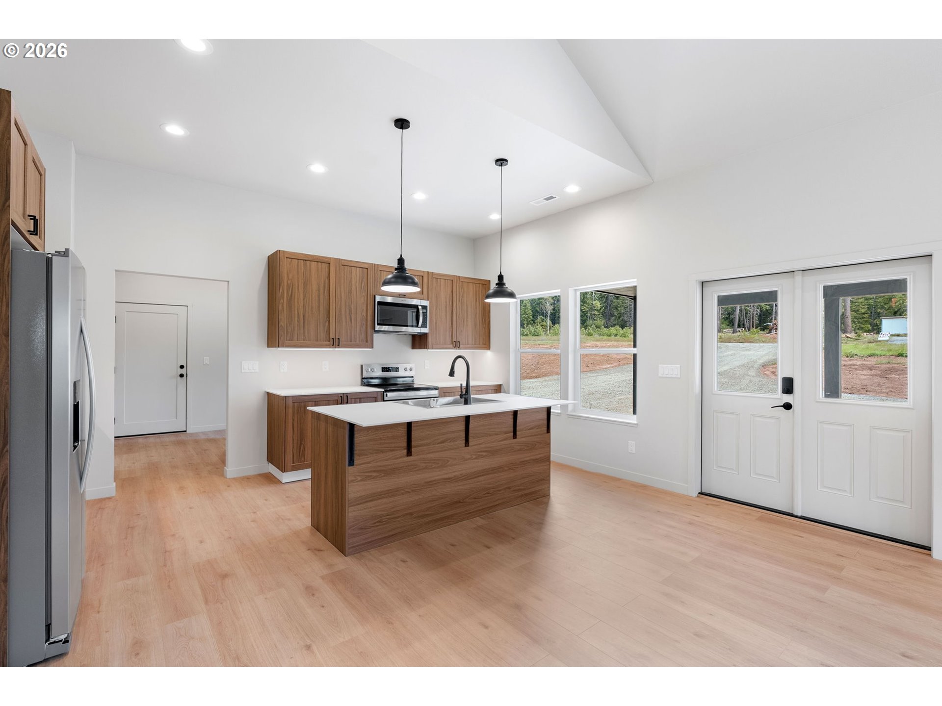 16 Snag Road Lyle, WA 98635 - Photo 5 of 43 a large white kitchen with kitchen island a sink stainless steel appliances and cabinets