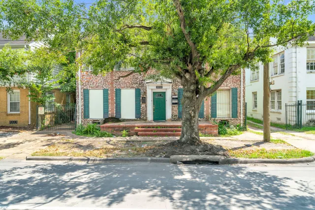 a view of a house with a tree in front
