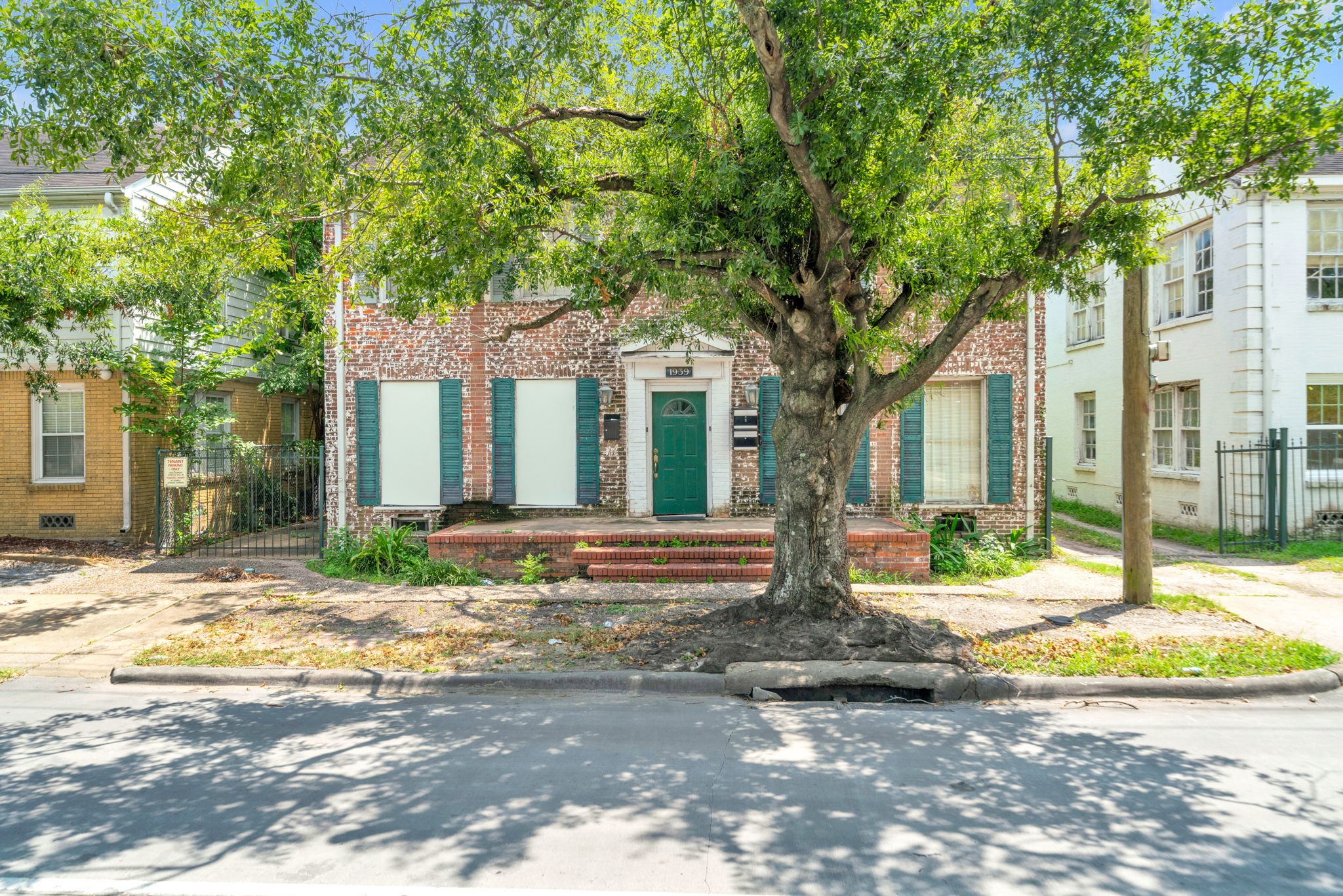 a view of a house with a tree in front