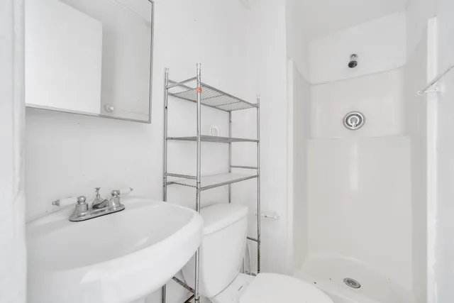 a bathroom with a sink toilet and shower
