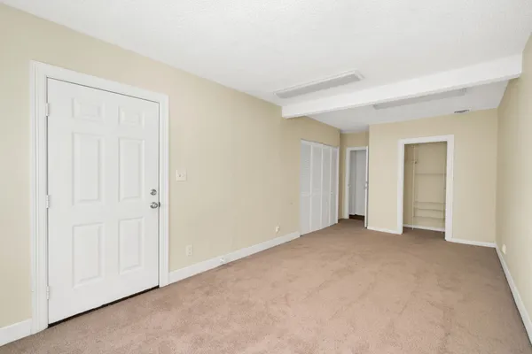 an empty room with closet area