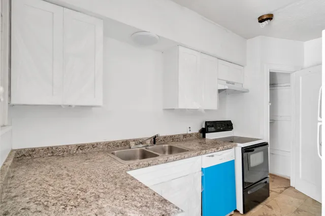 a kitchen that has a sink and a stove