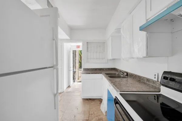 a kitchen with a stove a refrigerator and a sink