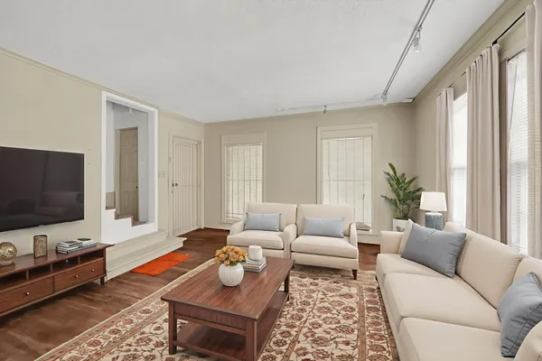 a living room with furniture and a flat screen tv