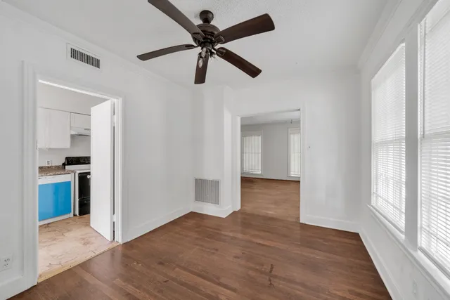 a view of a kitchen with a sink and wooden floor