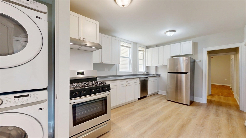 205 Chelsea Street, Unit 3 Boston, MA 02128 - Photo 1 of 33 a kitchen with a refrigerator sink and cabinets
