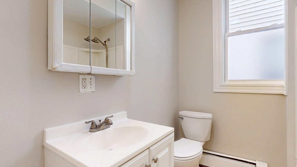 205 Chelsea Street, Unit 3 Boston, MA 02128 - Photo 12 of 33 a bathroom with a toilet a sink and mirror