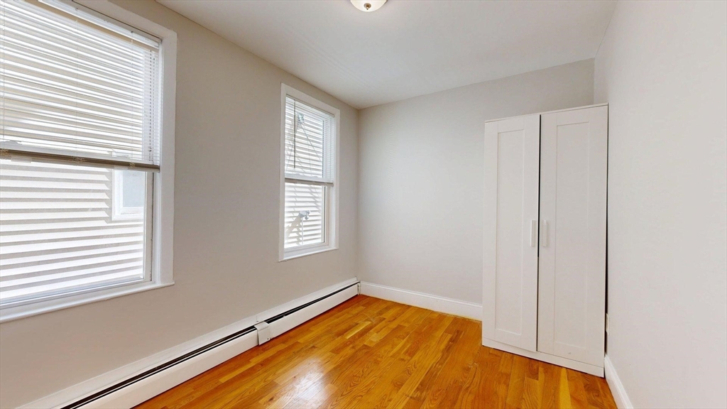 205 Chelsea Street, Unit 3 Boston, MA 02128 - Photo 14 of 33 a bed sitting in a bedroom next to a window