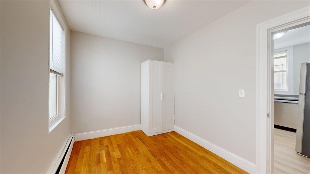 205 Chelsea Street, Unit 3 Boston, MA 02128 - Photo 15 of 33 a view of room with window and wooden floor