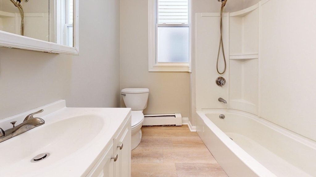 205 Chelsea Street, Unit 3 Boston, MA 02128 - Photo 18 of 33 a bathroom with a tub a sink and a window