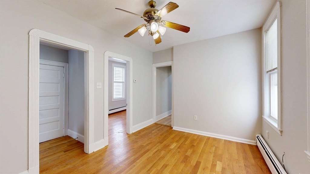 205 Chelsea Street, Unit 3 Boston, MA 02128 - Photo 2 of 33 a view of empty room with wooden floor and fan