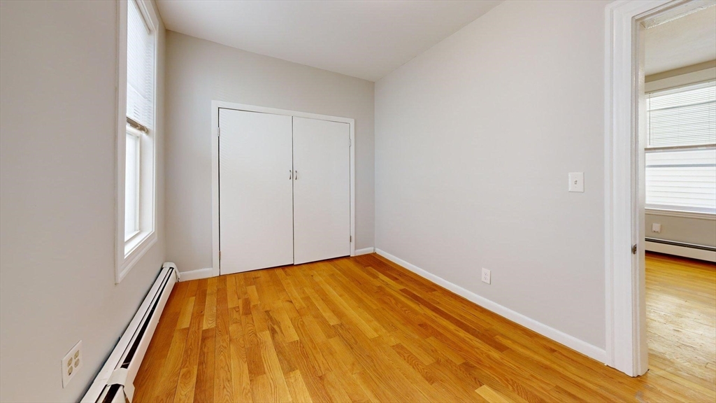 205 Chelsea Street, Unit 3 Boston, MA 02128 - Photo 24 of 33 a view of empty room with wooden floor