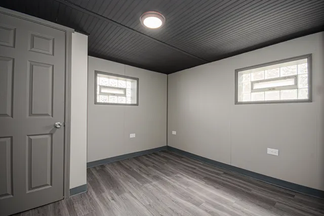 a backyard of a house with wooden floor and outdoor seating