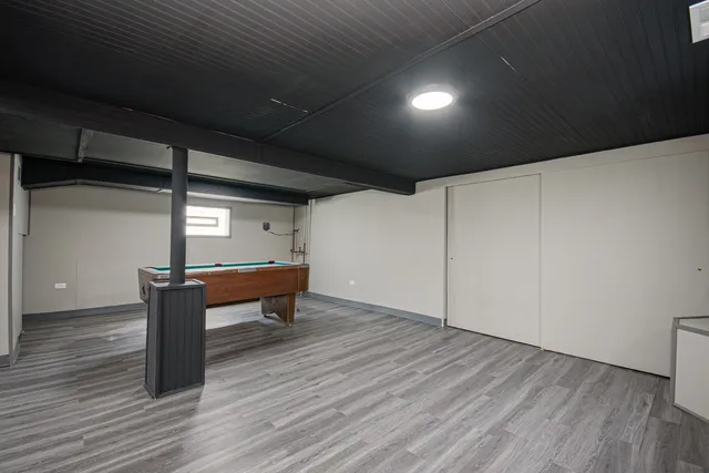 a room with wooden floor and furniture