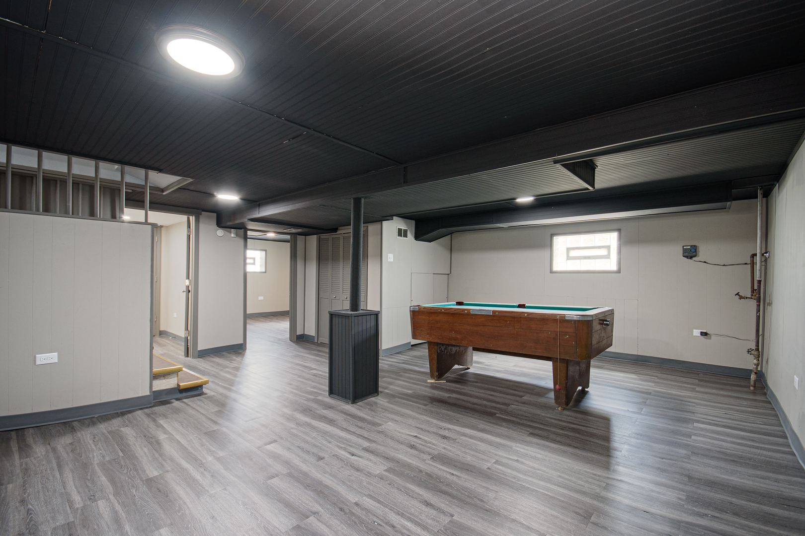 5533 South Menard Avenue Chicago, IL 60638 - Photo 23 of 26 a room with wooden floor and furniture