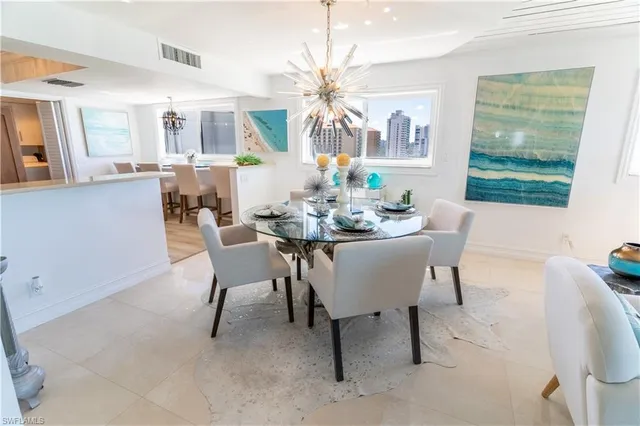 a dining room with furniture a livingroom and chandelier