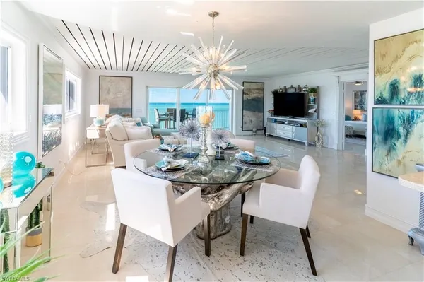 a view of a dining room with furniture and a flat screen tv
