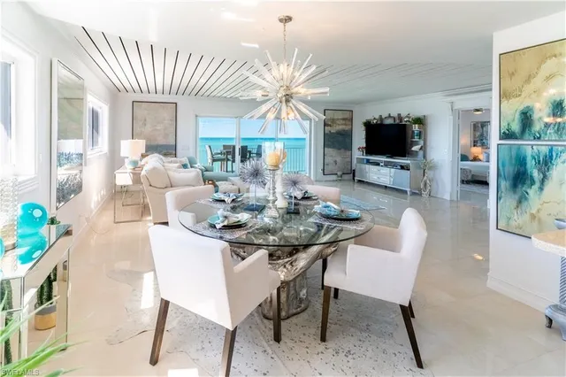 a view of a dining room with furniture and a flat screen tv