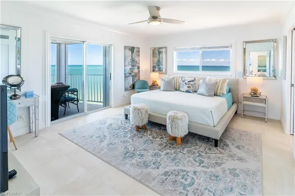 a bedroom with a bed and large mirror