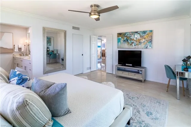 a bedroom with furniture and a flat screen tv
