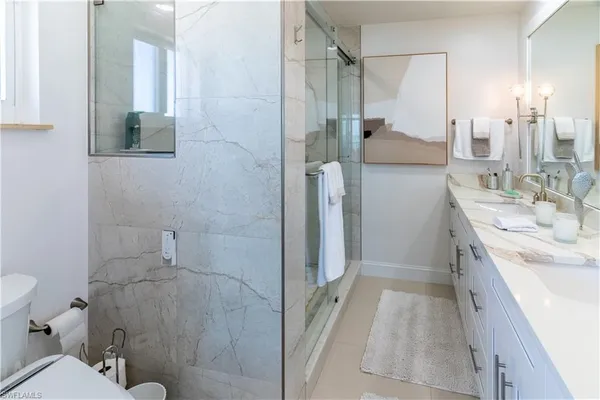 a bathroom with a sink a toilet and shower