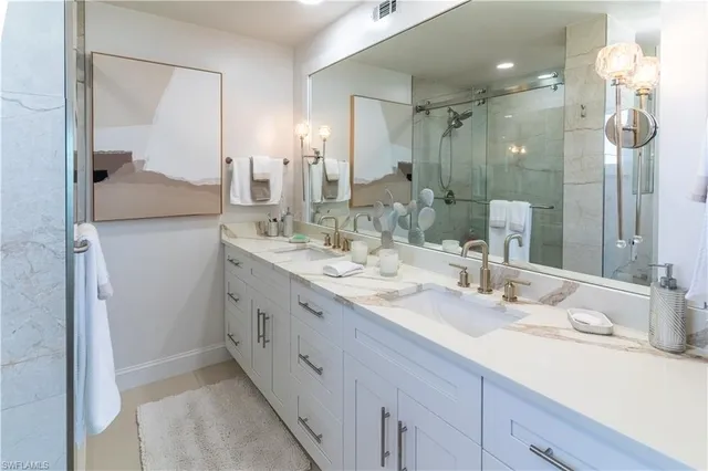 a bathroom with a double vanity sink mirror and double